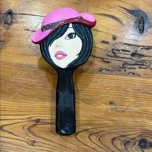 Black Hairbrush with woman face and hat painted on.